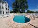 Community pool with brick patio and lounge chairs at 3127 W Sligh Ave # 104B, Tampa, FL 33614