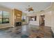 Open living room with a fireplace, kitchen island, and tile flooring at 3127 W Sligh Ave # 104B, Tampa, FL 33614