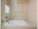Elegant bathroom with a large soaking tub and tile surround at 3127 W Sligh Ave # 104B, Tampa, FL 33614