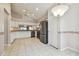 Open kitchen and dining area with stainless steel appliances and white cabinetry at 11609 Weaver Park Ct, Trinity, FL 34655