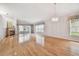 Bright living room featuring hardwood floors, a fireplace, and large windows at 11609 Weaver Park Ct, Trinity, FL 34655