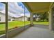 Screened porch overlooking a grassy backyard shared with other homes at 11609 Weaver Park Ct, Trinity, FL 34655