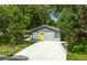 House with driveway and large backyard surrounded by trees at 1334 Fairmont St, Clearwater, FL 33755