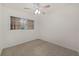 Bright bedroom with window, ceiling fan, and neutral-toned carpet at 2452 Chaucer St, Clearwater, FL 33765