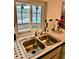 Double kitchen sink with a window overlooking the pool at 1728 W Lagoon Cir, Clearwater, FL 33765