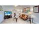 Living room with tile floors, sofa, and TV at 12760 Indian Rocks Rd # 1004, Largo, FL 33774