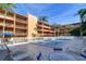 Community pool with plenty of lounge chairs for relaxing at 12760 Indian Rocks Rd # 1004, Largo, FL 33774