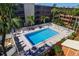 Community pool with lounge chairs and fenced-in area at 12760 Indian Rocks Rd # 1004, Largo, FL 33774