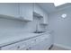 Bright eat-in kitchen with white cabinets and marble countertops at 12760 Indian Rocks Rd # 1004, Largo, FL 33774
