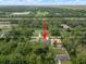 Aerial view of a house in a residential neighborhood with surrounding trees at 3616 Bellefonte Ave, North Port, FL 34286