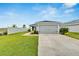 Front view of house with gray garage door at 6787 Abbywood Ln, Zephyrhills, FL 33541