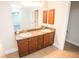 Double vanity bathroom with wood cabinets and granite countertop at 14211 Edinburgh Moor Dr, Wimauma, FL 33598