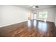 Large living room with hardwood floors and lots of natural light at 14211 Edinburgh Moor Dr, Wimauma, FL 33598