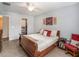 Main bedroom with a sleigh bed, ceiling fan, and walk-in closet at 2748 Birchcreek Dr, Wesley Chapel, FL 33544