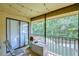 Screened balcony overlooking a wooded area with string lights at 10100 Sailwinds N Blvd # 205, Largo, FL 33773