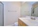 Bathroom with a single sink vanity, shower, and mirror at 10100 Sailwinds N Blvd # 205, Largo, FL 33773
