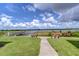Community lake access with benches and a pier at 10100 Sailwinds N Blvd # 205, Largo, FL 33773