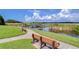 Serene lakeside view with a wooden pier and benches at 10100 Sailwinds N Blvd # 205, Largo, FL 33773