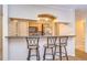 Breakfast bar with granite countertop and three stools at 10100 Sailwinds N Blvd # 205, Largo, FL 33773