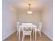 Charming dining area with a white table and four chairs at 10100 Sailwinds N Blvd # 205, Largo, FL 33773