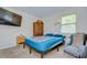Bedroom with a teal bedspread, dresser, and window coverings at 10100 Sailwinds N Blvd # 205, Largo, FL 33773