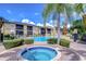 Community pool and spa with lounge chairs and lush landscaping at 10100 Sailwinds N Blvd # 205, Largo, FL 33773