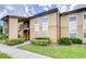Tan building exterior with landscaping and a staircase at 10100 Sailwinds N Blvd # 205, Largo, FL 33773
