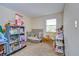 bedroom with crib, toy shelves and window coverings at 10100 Sailwinds N Blvd # 205, Largo, FL 33773