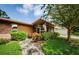 Brick home's front entrance with screened porch and landscaping at 2241 Shelly Dr # B, Palm Harbor, FL 34684