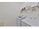 Laundry room with washer, dryer, and shelving at 6378 Camino Dr, Apollo Beach, FL 33572