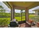 Screened porch with brick flooring and grill at 6378 Camino Dr, Apollo Beach, FL 33572