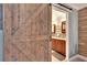 Ensuite bathroom with a modern vanity, tile shower, and barn door entry at 103 Capri N Ct, Plant City, FL 33566