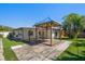 Backyard with a gazebo, lush artificial grass, and a well-maintained home exterior at 6750 W Flamingo S Way, St Petersburg, FL 33707