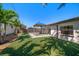 Expansive backyard featuring artificial turf, gazebo, and mature trees, perfect for outdoor entertaining at 6750 W Flamingo S Way, St Petersburg, FL 33707