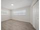 Bedroom featuring two windows with blinds, a closet, and wood-look flooring at 6750 W Flamingo S Way, St Petersburg, FL 33707