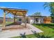 Exterior of a well-maintained home featuring a gazebo, manicured lawn, and welcoming curb appeal at 6750 W Flamingo S Way, St Petersburg, FL 33707