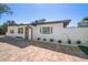 Charming single story home with brick driveway, manicured lawn and beautiful landscaping at 6750 W Flamingo S Way, St Petersburg, FL 33707