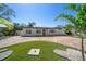 Welcoming home with brick driveway and well-maintained lawn with decorative landscaping at 6750 W Flamingo S Way, St Petersburg, FL 33707