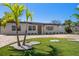Inviting home with a spacious brick driveway, manicured lawn, and attractive landscaping at 6750 W Flamingo S Way, St Petersburg, FL 33707