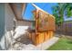 Private outdoor hot tub with wooden privacy screen, set on a paved patio and artificial grass at 6750 W Flamingo S Way, St Petersburg, FL 33707