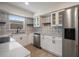 Bright kitchen featuring stainless steel appliances, white cabinets, and decorative tile backsplash at 6750 W Flamingo S Way, St Petersburg, FL 33707