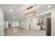 Bright and airy living room featuring new wood flooring that opens to an adjacent kitchen at 6750 W Flamingo S Way, St Petersburg, FL 33707