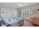 Guest bedroom with window shutters and a comfortable armchair at 10713 Cape Hatteras Dr, Tampa, FL 33615