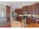 Well-equipped kitchen featuring dark wood cabinets and granite countertops at 10713 Cape Hatteras Dr, Tampa, FL 33615