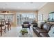 Gathering room showcasing leather sofas, a glass coffee table, and pool access at 10713 Cape Hatteras Dr, Tampa, FL 33615