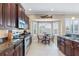 Kitchen boasts dark wood cabinets, stainless steel appliances, and breakfast nook at 10713 Cape Hatteras Dr, Tampa, FL 33615