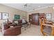 Relaxing Gathering room with leather furniture, built-in shelving, and ceiling fan at 10713 Cape Hatteras Dr, Tampa, FL 33615