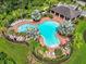 Community pool with lounge chairs and shaded areas at 35716 Hillbrook Ave, Zephyrhills, FL 33541