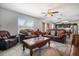 Spacious living room featuring brown leather furniture and a large coffee table at 35716 Hillbrook Ave, Zephyrhills, FL 33541