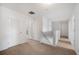 Upstairs hallway with carpeted floors and doors to bedrooms and bathroom at 35716 Hillbrook Ave, Zephyrhills, FL 33541